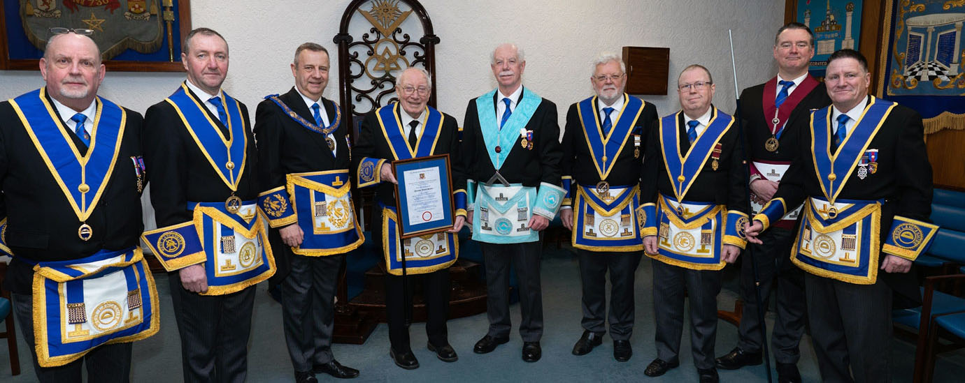 Norman flanked by Peter Lockett (left) and Patrick Martindale, with the Provincial grand officers in attendance.