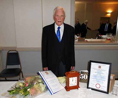 Herbie with his certificate, card, clock, explanation of his career and flowers.