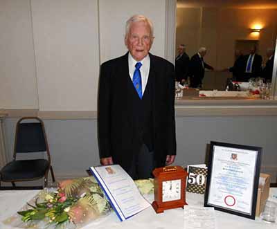 Herbie with his certificate, card, clock, explanation of his career and flowers. Herbie with his certificate, card, clock, explanation of his career and flowers.
