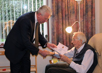 Mark Matthews presents the certificate and offers his congratulations. Mark Matthews presents the certificate and offers his congratulations.