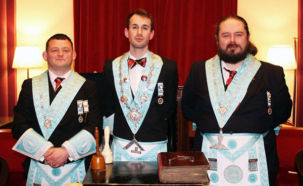 Pictured from left to right, are: Junior warden Adam, WM Liam and senior warden Wayne wearing their centenary jewels with pride