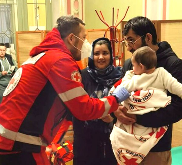 A Red Cross medic in Poland helping a family newly arrived from Ukraine.