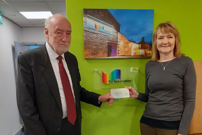 Derek hands over the donation to Andrea Baker of the Space Centre.