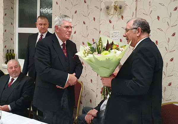 Steve Willingham (right) presents Tony with flowers for Maureen.