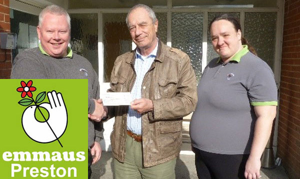 Paul McKernan (centre) presents a cheque for £250 to representatives of Emmaus Preston.