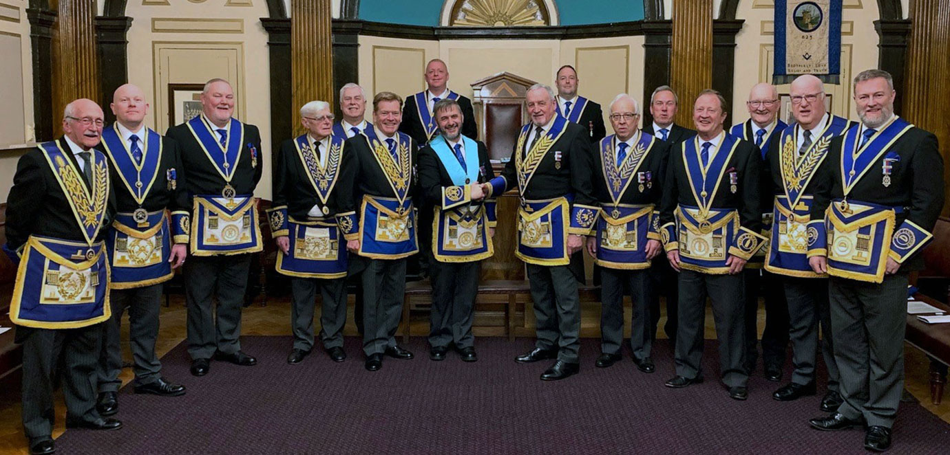 Pictured from left to right front circle, are: Mike Winterbottom, Malcolm Bell, Gary Smith, Tom Lovatt, Kevin Poynton, Robb Fitzsimmons, Sam Robinson, Malcolm Alexander, Paul Broadley, Steve Walls and Dave Boyes. Standing in the rear circle are: Dave Johnson, Provincial Senior Grand Warden Daniel Crossley, Provincial Junior Grand Warden Benjamin Gorry, Ray Parr and Stew Hyde.