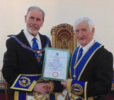 Frank Umbers (left) presenting John Wallbank with his Jubilee certificate.
