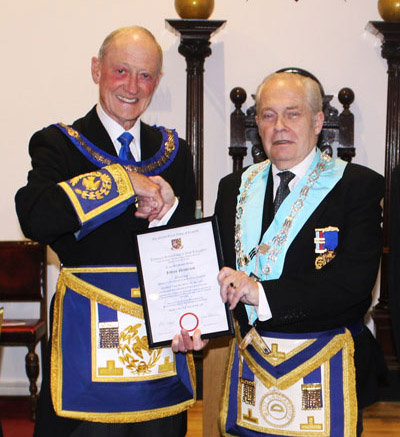 Jeff (right) receives his 50th anniversary certificate from Barry Jameson.