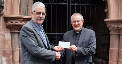 Revd Michael Ridley was delighted to receive the donation from Andy Barton.