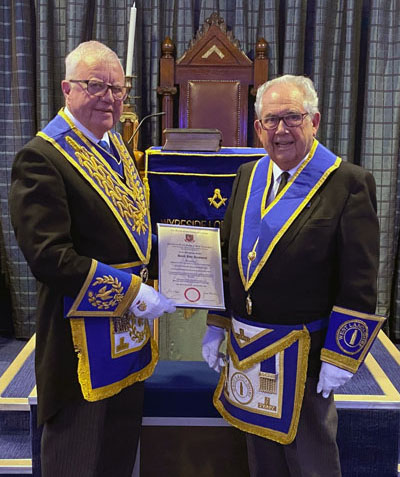 Keith Kemp (left) presents David Ainsworth with his 60 years’ service certificate.