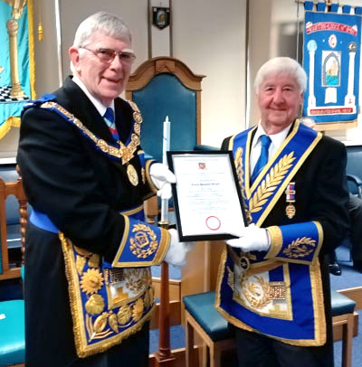 Tony Harrison (left) presents Jim Wilson with his 50-year certificate.
