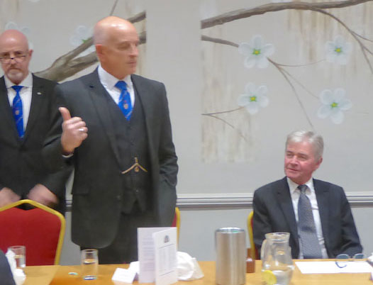 Pictured from left to right, are standing: DC Steven Williams, while Graham Fairley proposes a toast to Stephen White.