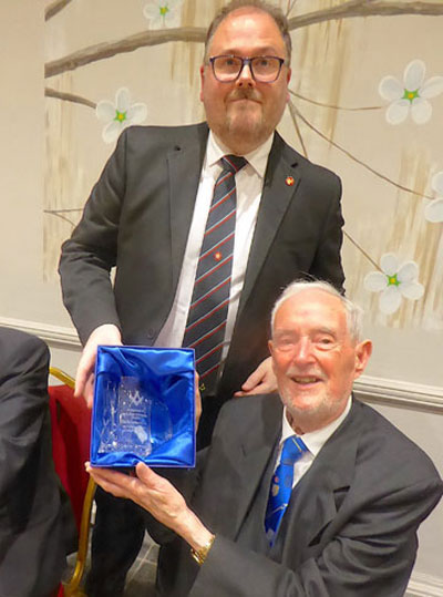 Adam Kennaugh (standing) presents Ron Everard with a gift from the lodge. Adam Kennaugh (standing) presents Ron Everard with a gift from the lodge.