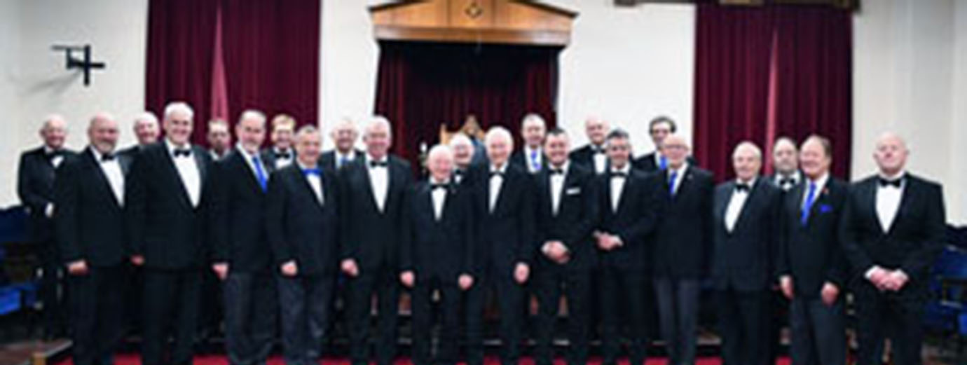 Pictured are: Howard Jones and Mark Matthews (centre), together with the grand officers, the Provincial team and members of Lodge of Peace and Unity.