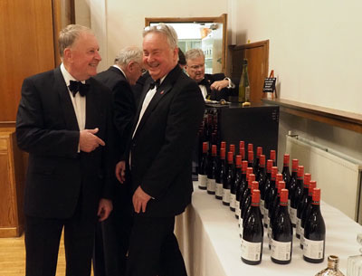 Lodge steward Mike Middleton (left) jokes with Steven Carr over the quantity of wine.