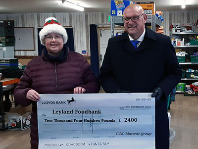 Dave Bishop (group vice chairman) presenting a cheque to Celia Neill at the Leyland Food Bank. Dave Bishop (group vice chairman) presenting a cheque to Celia Neill at the Leyland Food Bank.