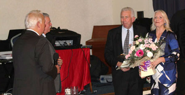 Mark and Debbie Matthews receive flowers from Paul and Steve. 