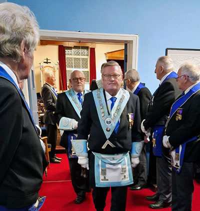 WM of Ribbleton Lodge Peter Gaudion leads the members through a ‘Guard of Honour’ made by visitors.