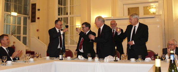 Ian Sanderson (standing left) toasts the three principals, looked on by John James Ian Sanderson (standing left) toasts the three principals, looked on by John James