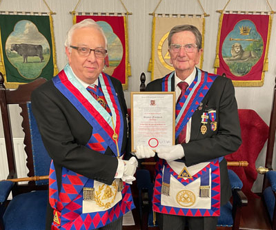 Malcolm Alexander (left) presents Stanley Fairhurst with his certificate.