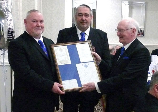 Ray (right) admires a memento of the evening with Gary Smith (left) and Gary Fisher Ray (right) admires a memento of the evening with Gary Smith (left) and Gary Fisher