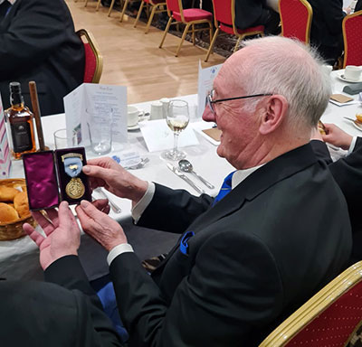 Ray examines the founding master’s jewel. Ray examines the founding master’s jewel.