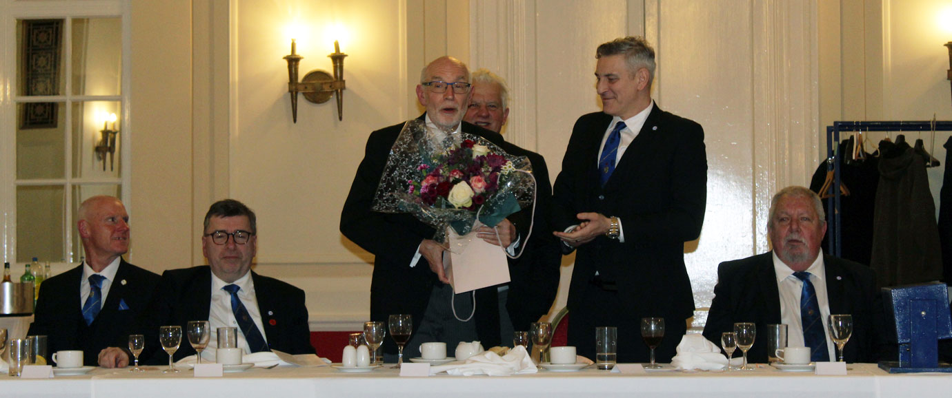 Stuart Allen (right) present John James with flowers in token of appreciation.