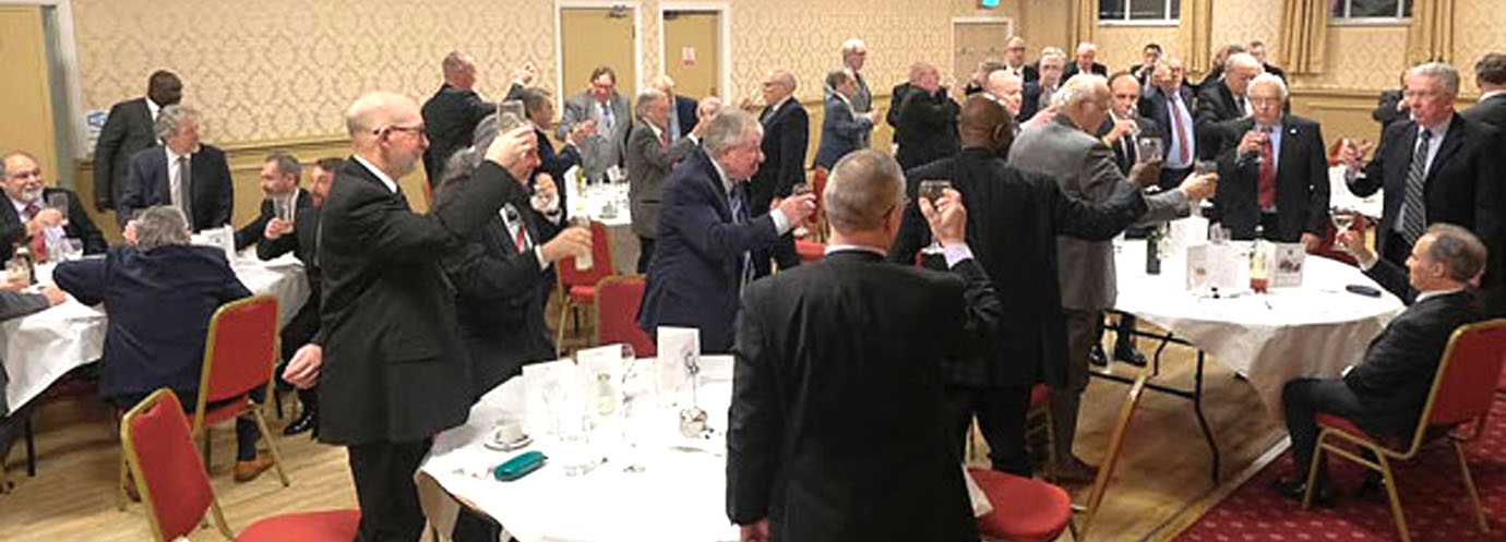 The brethren drink the toast to group chairman Jonathan Heaton.