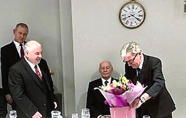 Stephen presents Chris with flowers. Stephen presents Chris with flowers.