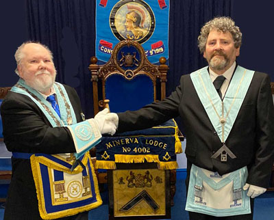 Iain thanks Arnie (right) for the way he installed him in the chair. Iain thanks Arnie (right) for the way he installed him in the chair.