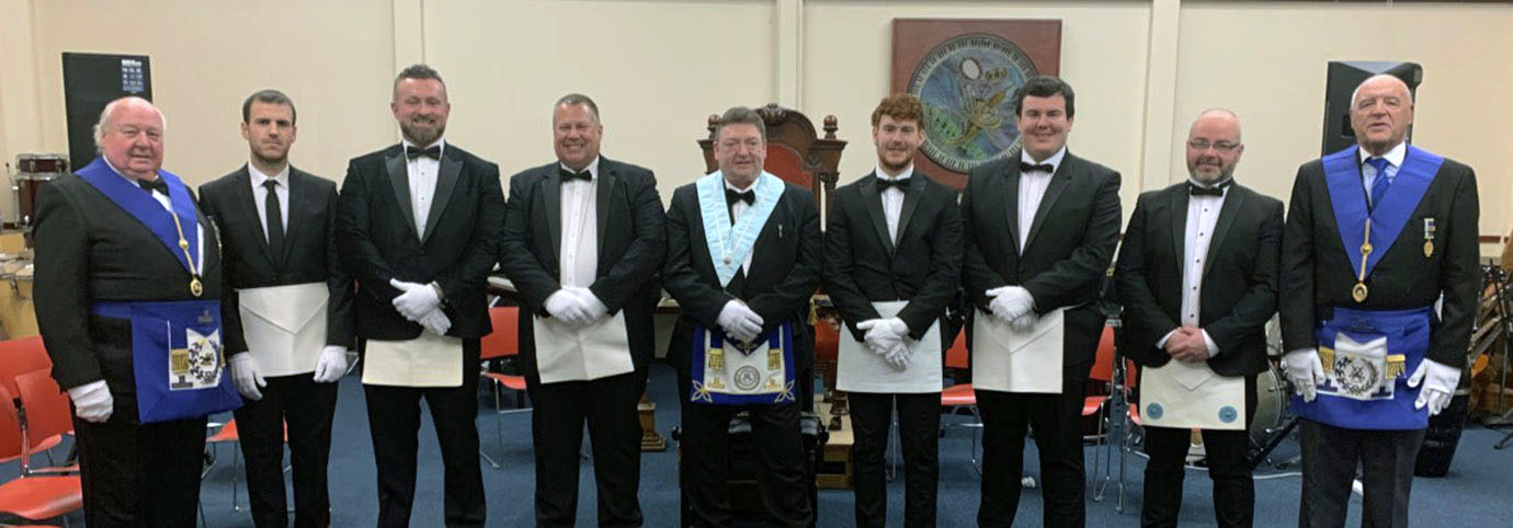Visiting grand officers Steven Kayne (right) and Peter Levick (left) flanking the entered apprentices and fellow craft; centred by Peter McGrady.