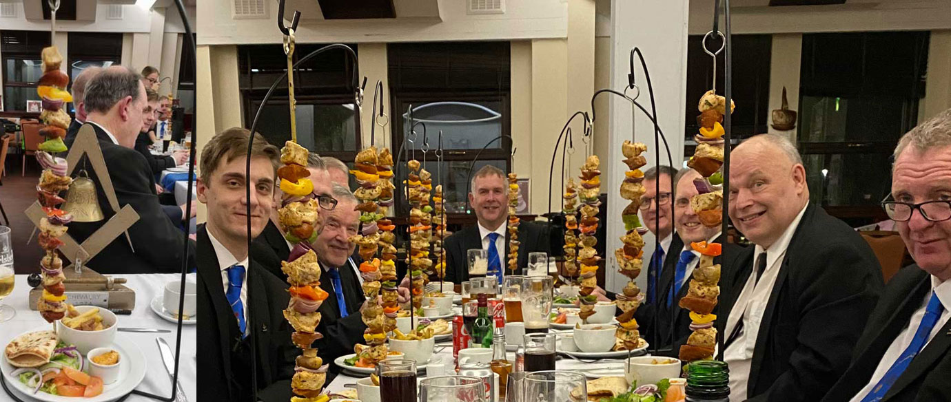 Pictured left: The WMs hanging kebabs. Pictured right: The brethren are served with their hanging kebabs.