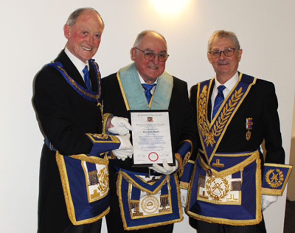 Pictured from left to right, as John receives his 50th anniversary certificate, are: Barry Jameson, John Newall and Gareth Jones.