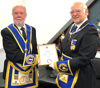 Gerald Eaves (left) receiving his certificate and congratulations from David Ogden.