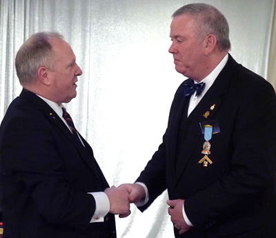 Juan Topping (right) having received the past-master’s jewel from Mark Smith. Juan Topping (right) having received the past-master’s jewel from Mark Smith.