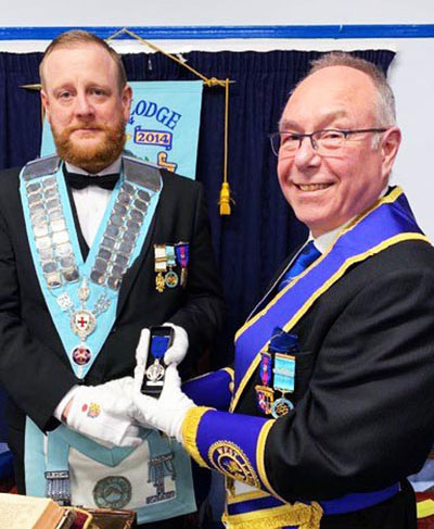 Richard McHale (right) presenting the Hall Stone Jewel to WM Ron Elliott. Richard McHale (right) presenting the Hall Stone Jewel to WM Ron Elliott.