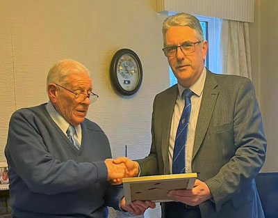 Andy Barton (right) presenting Stan Churm with his certificate.