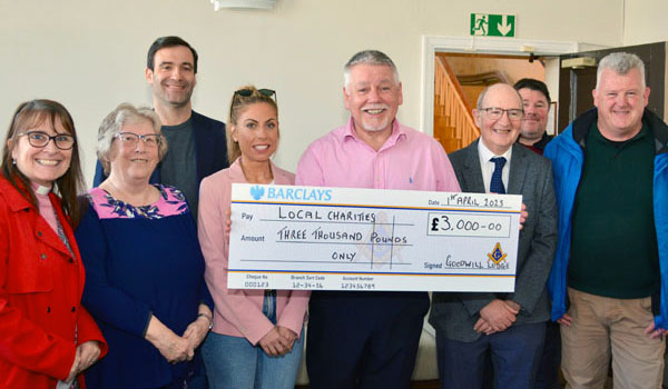 Bob Williams (centre) supported by John Gibbon, group vice chairman (third right) and Chris Farley (rear left) with representatives of local charities. Bob Williams (centre) supported by John Gibbon, group vice chairman (third right) and Chris Farley (rear left) with representatives of local charities.