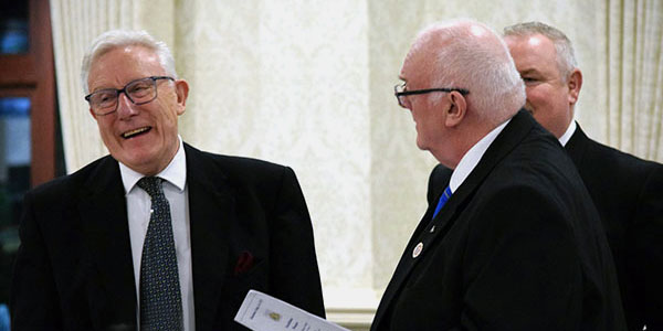 Ian Higham (left) and immediate past master Peter Lambert with Gary smith watching from behind. Ian Higham (left) and immediate past master Peter Lambert with Gary smith watching from behind.