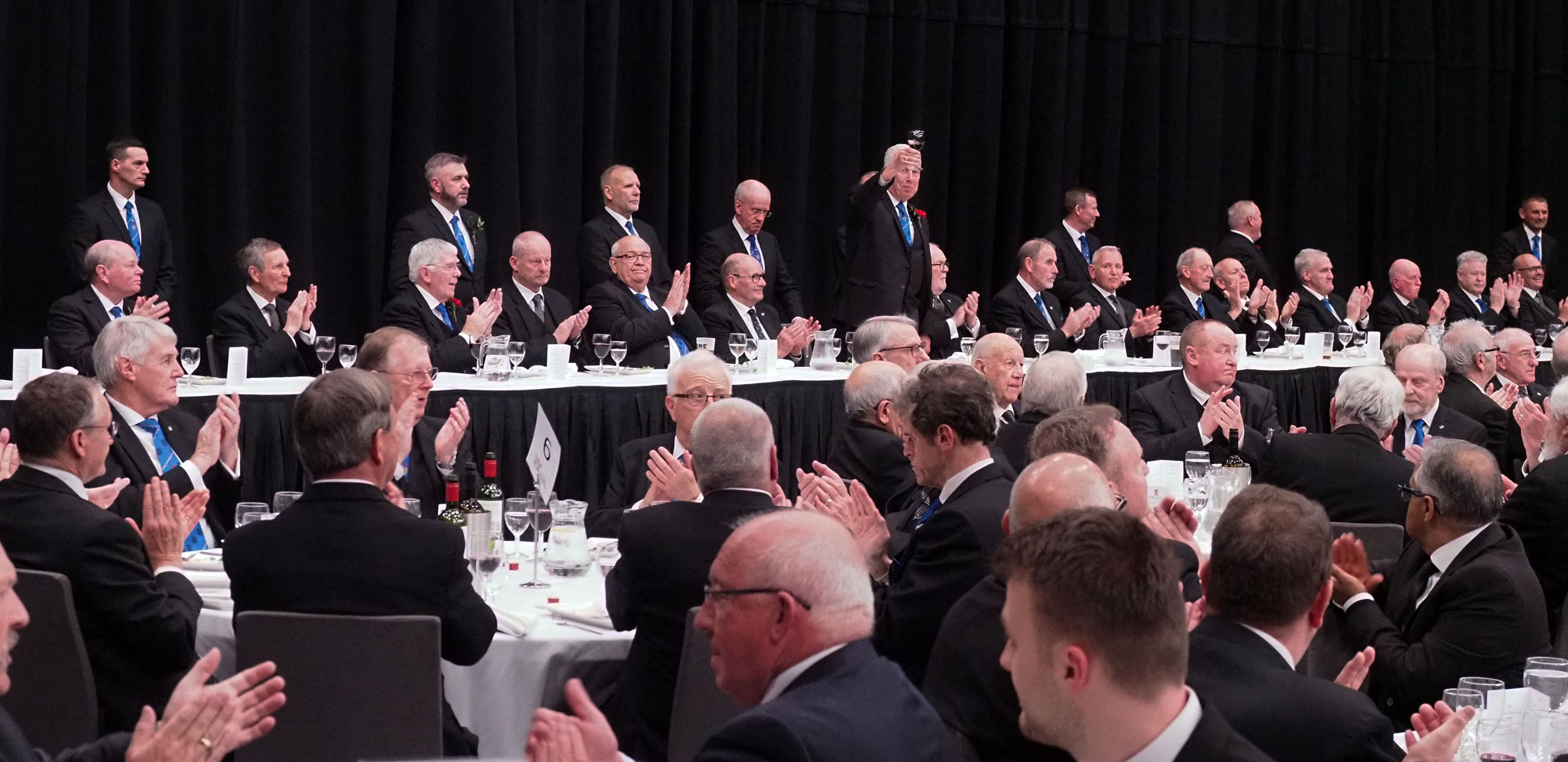 Mark Matthews raises a glass to the dinner guests at the banquet. Mark Matthews raises a glass to the dinner guests at the banquet.