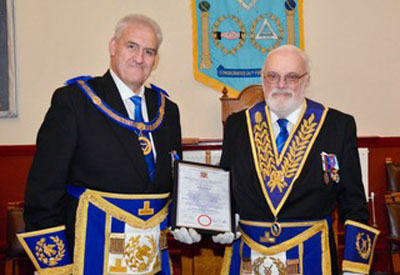 Andrew presents David with his certificate. Andrew presents David with his certificate.