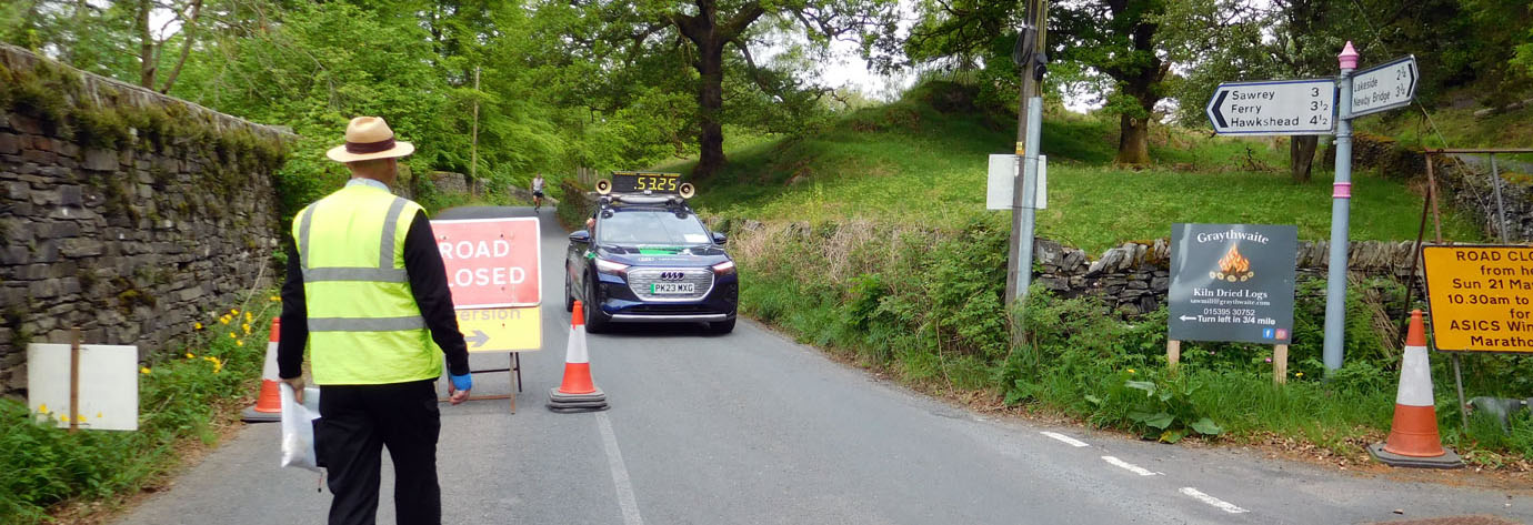 Simon Stringer of Semper Sursum Lodge sees the lead car through checkpoint 14 with Beau Smith in hot pursuit.