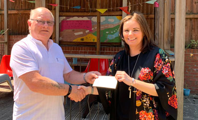 Cliff Jones presents a cheque to Faye Atherton of Young Carers. Cliff Jones presents a cheque to Faye Atherton of Young Carers.