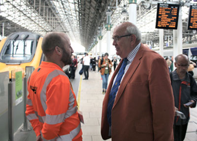 Safety Manager Chris McLoughlin from British Rail (left) explains to Phil the nature of the problem.