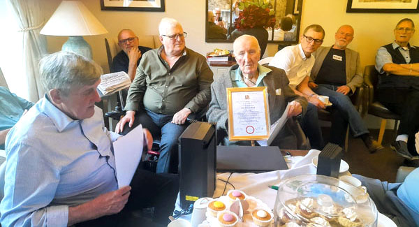 John Walsh holding his certificate.