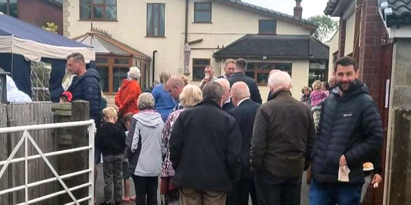 Guests lined up to enjoy a BBQ banquet. Guests lined up to enjoy a BBQ banquet.