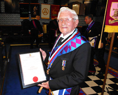 John Davies with the certificate of promotion.