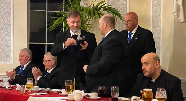 Chris Taylor (standing left) toasting the new master, Allan Archer.