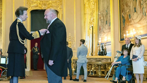 Chris receiving his presentation from the Princess Royal.