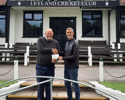 Graham Fish (left) presents Mark Sutch a cheque for £2,000 with the new covers in the foreground.